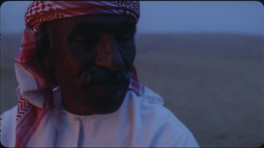 A man talks with someone in the desert