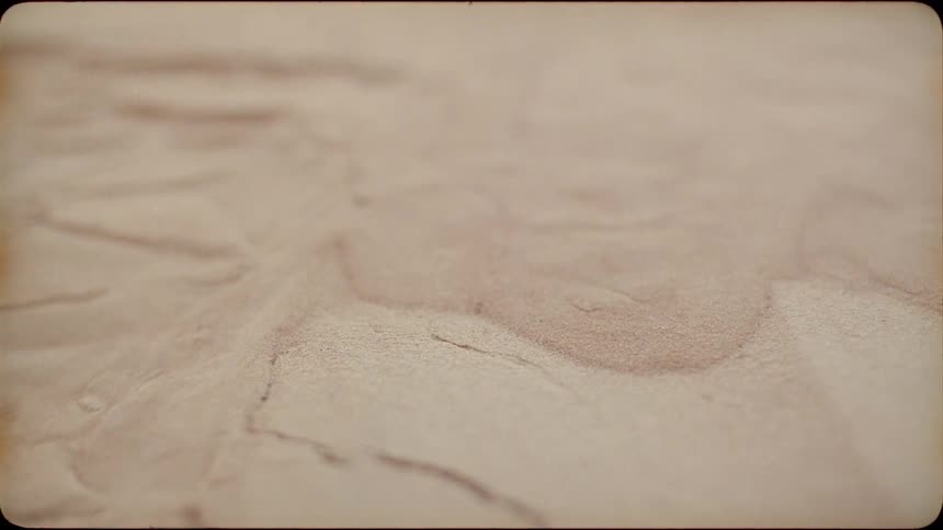 The sand breaks apart and falls