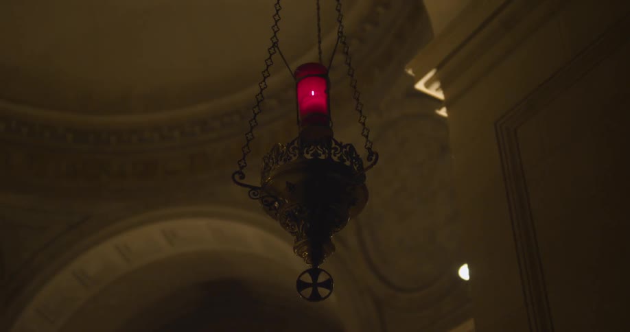 A light fixture hangs from a stone ceiling