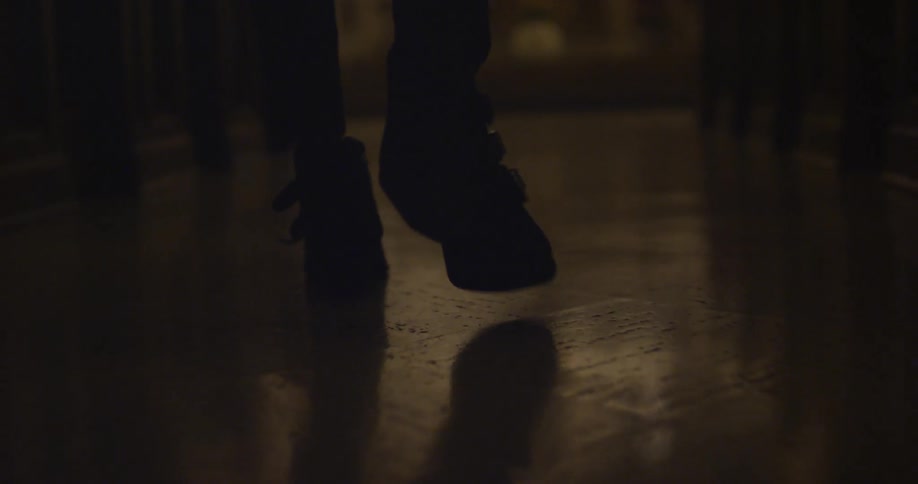Person walking down a darkly lit hallway