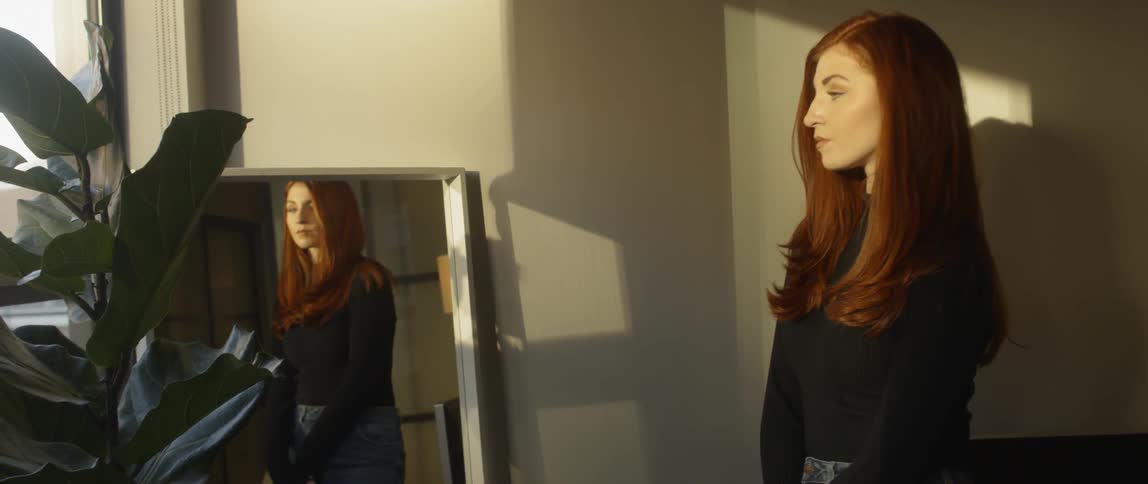 Woman poses in a an empty room