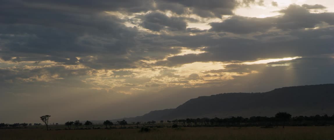 Sun shines through clouds over flat plains