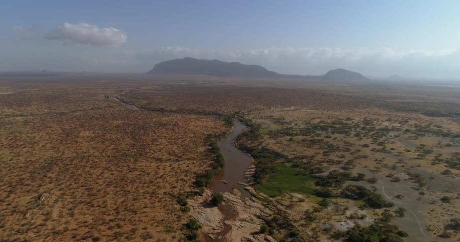 Small stream runs through a large flat desert