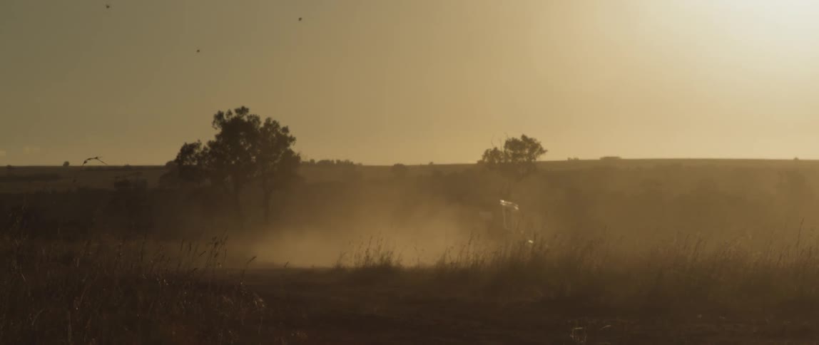 A jeep travels through the field