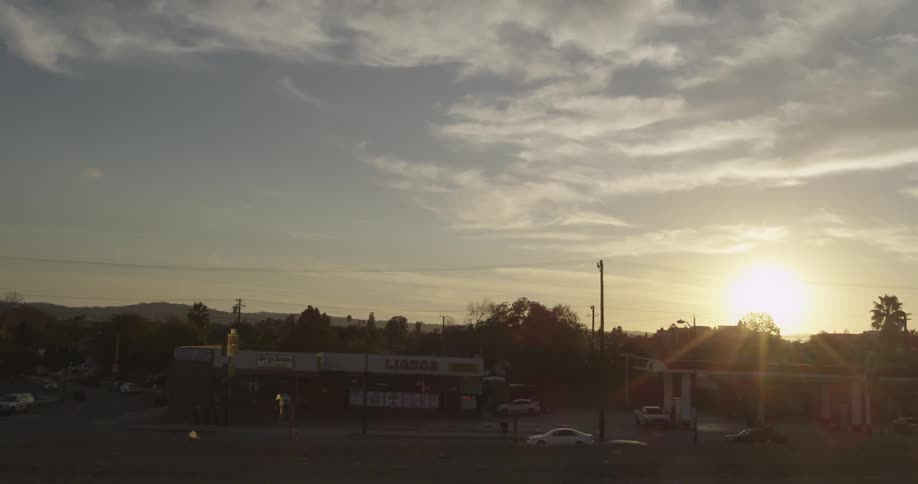 Sun rising in the distance over a town