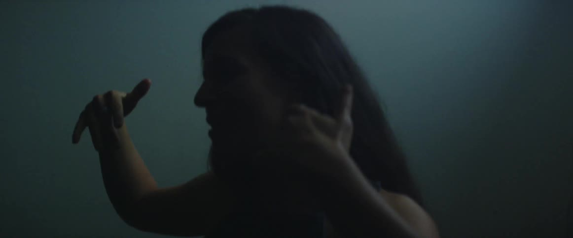 Woman sings and moves her arms around