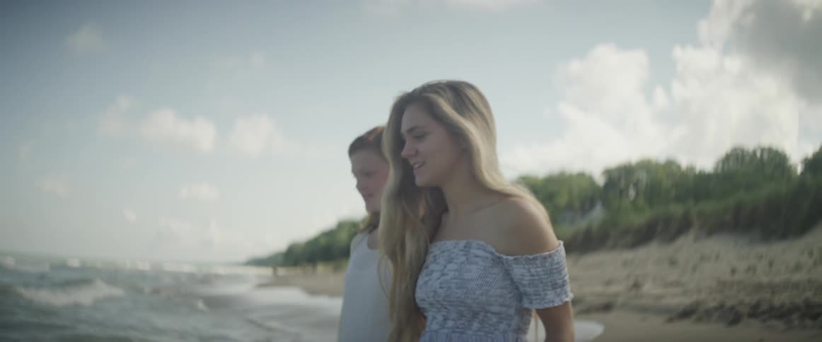 Two women stepping into the ocean