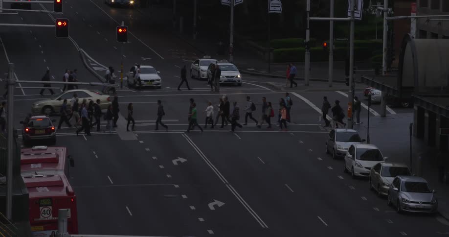 View of pedestrians and cars in a busy downtown area