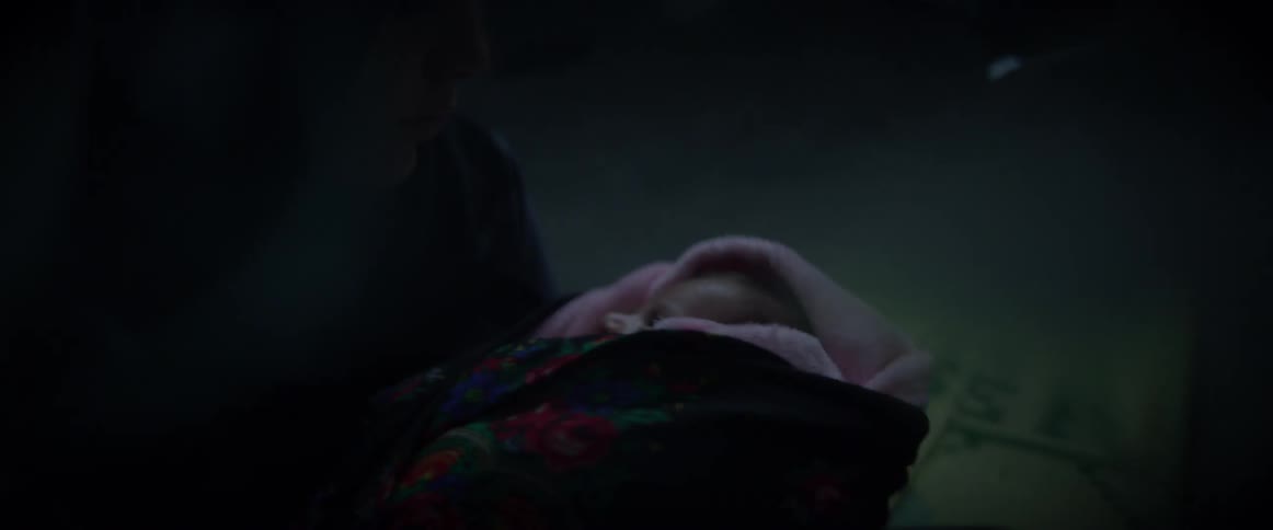 Baby wrapped in a blanket crying