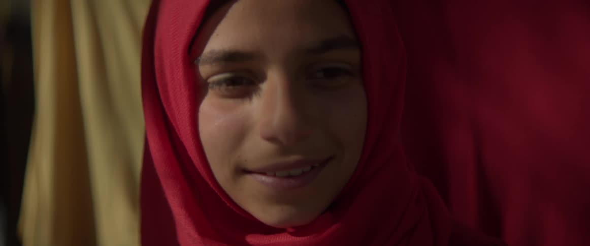 Woman looks up, speaks and smiles