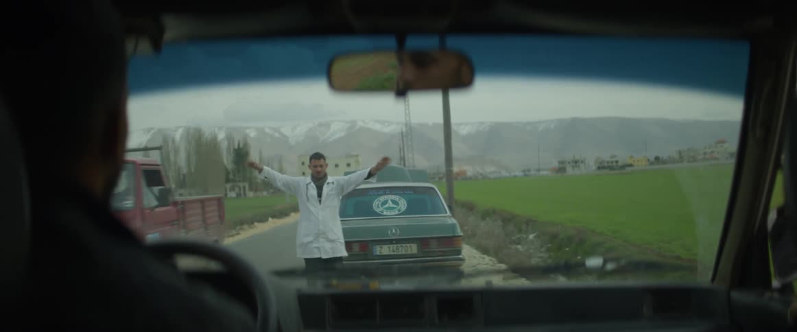 Man pulls over to help a broken down car on a rural road