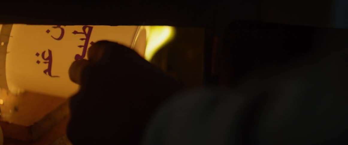 Man pushes a white container into a fire