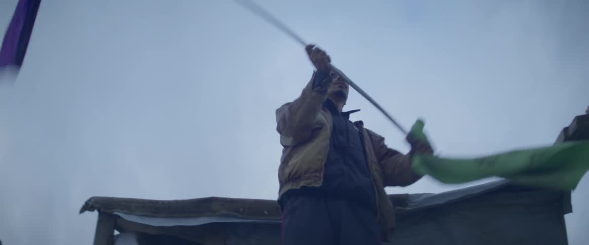 Man standing outside waving a flag