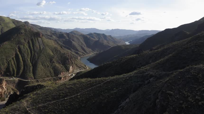 Stream flows in between several large mountains