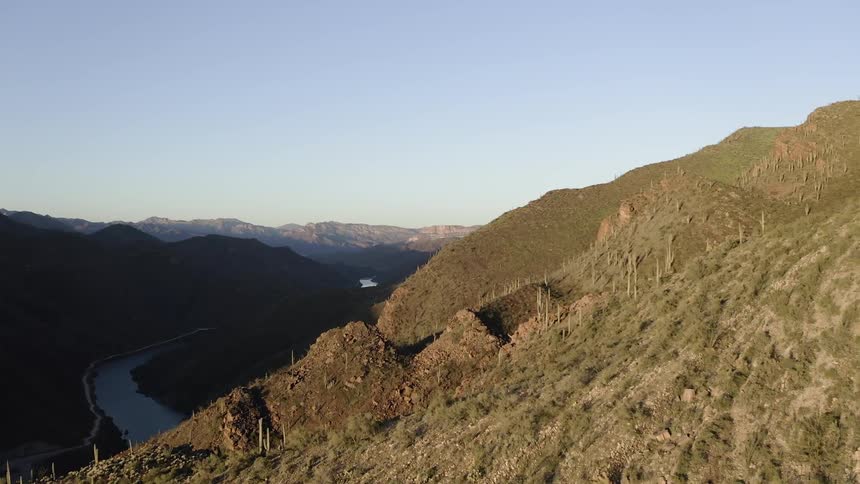 Stream winds through grassy mountains