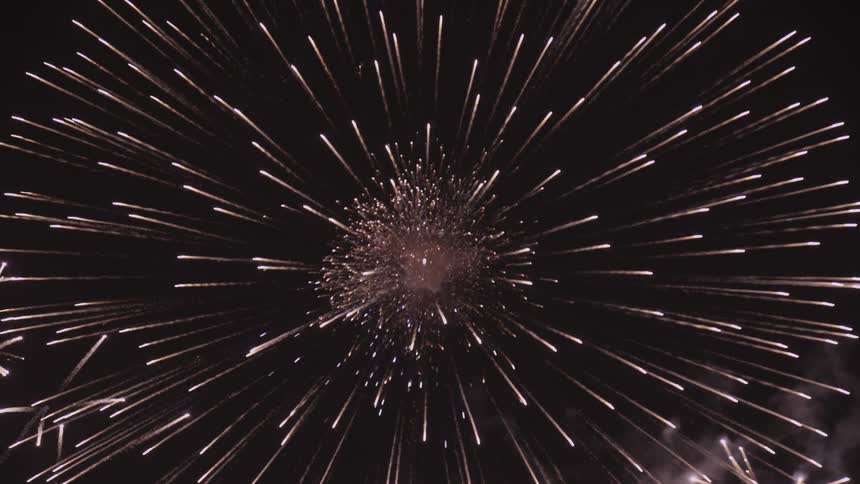 Fireworks exploding brightly in a night sky