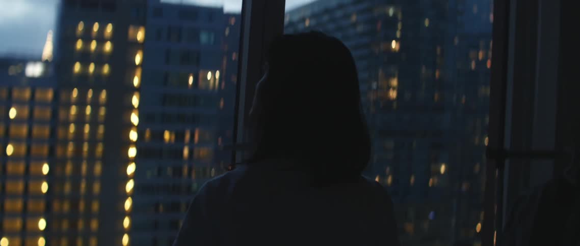 A person standing in front of a window