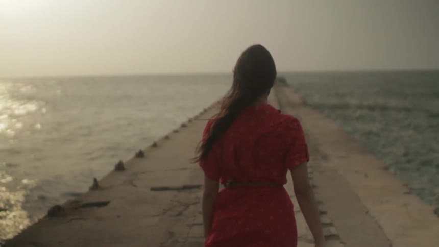 A person walking down a pier