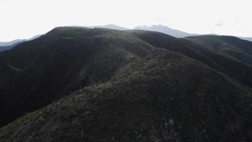 Mountains sit under a cloudy sky