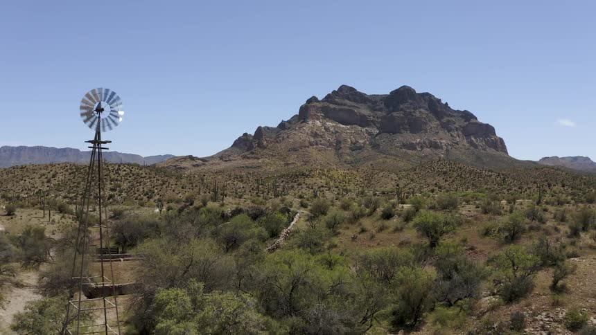 Windmill, desert hills and mountains