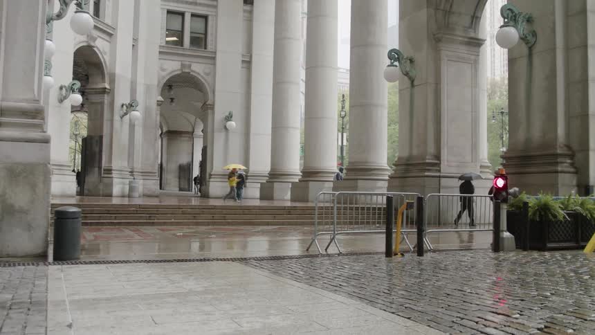 People walk with umbrellas on a rainy day