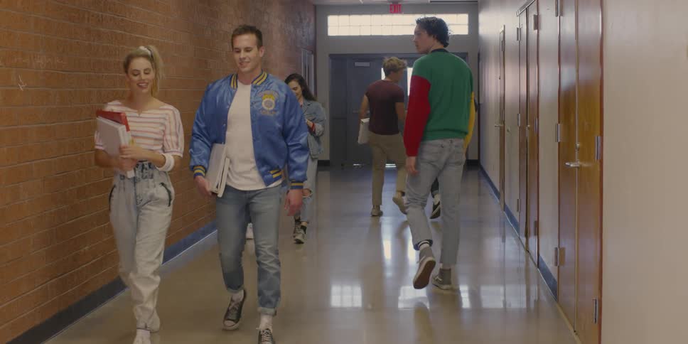 Students walk down school hallway