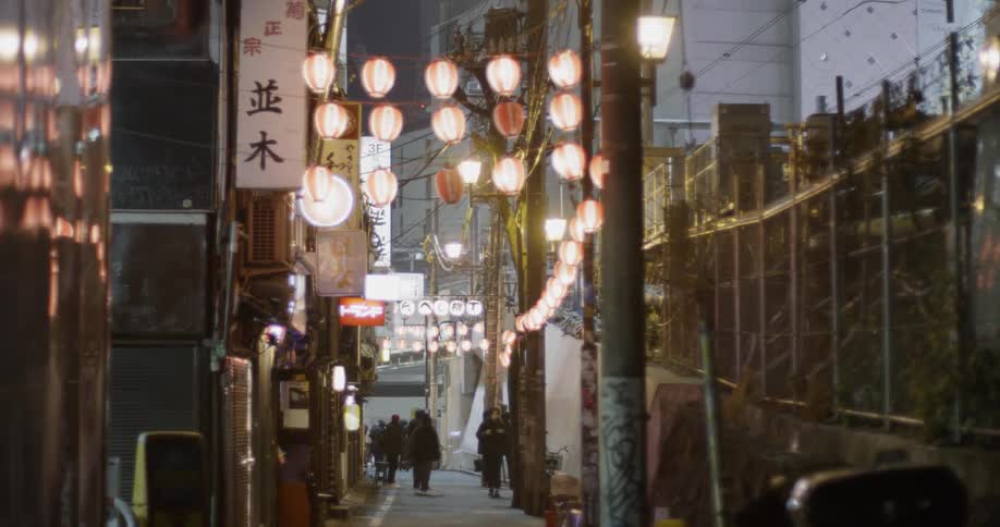 The alley is full of people in the distance