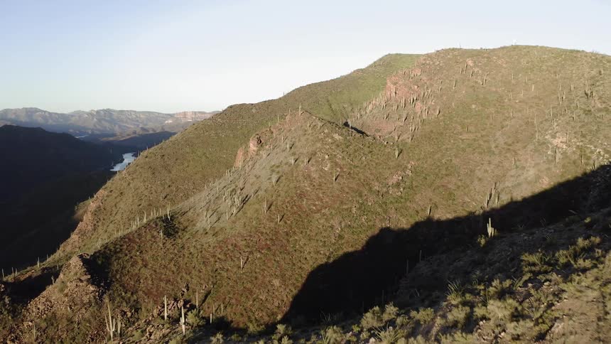 The tall hill is covered with green