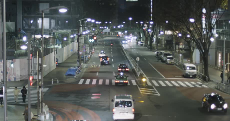 Cars pass through urban intersection