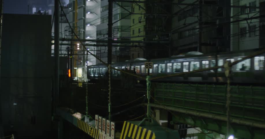 Train passes through a city at night