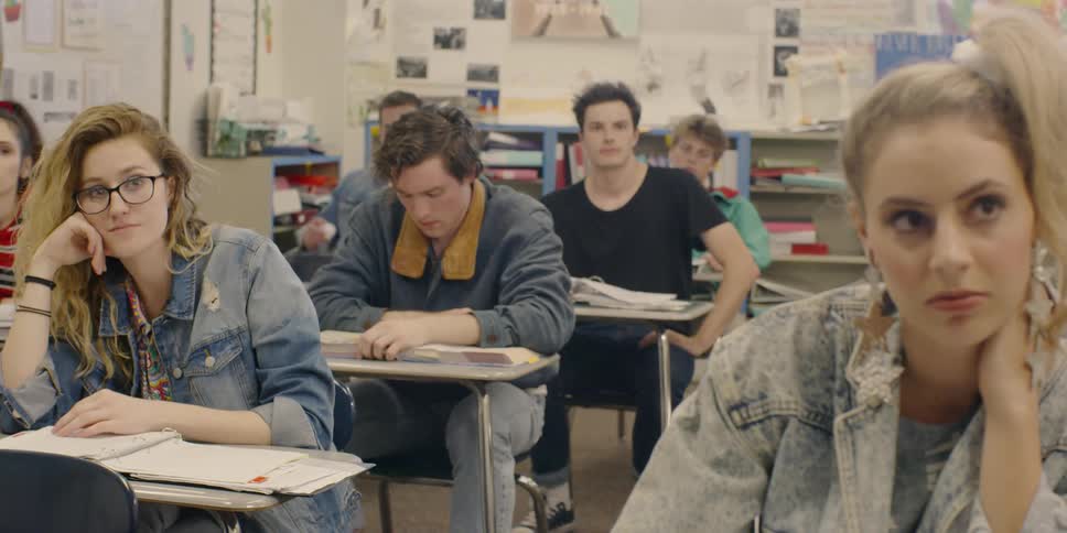 Student throws paper at the back of another student