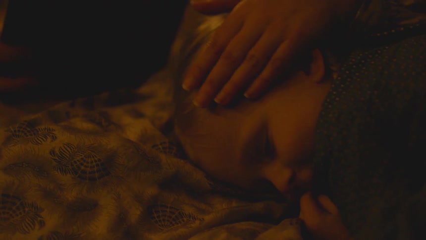 Hand pets a child's head