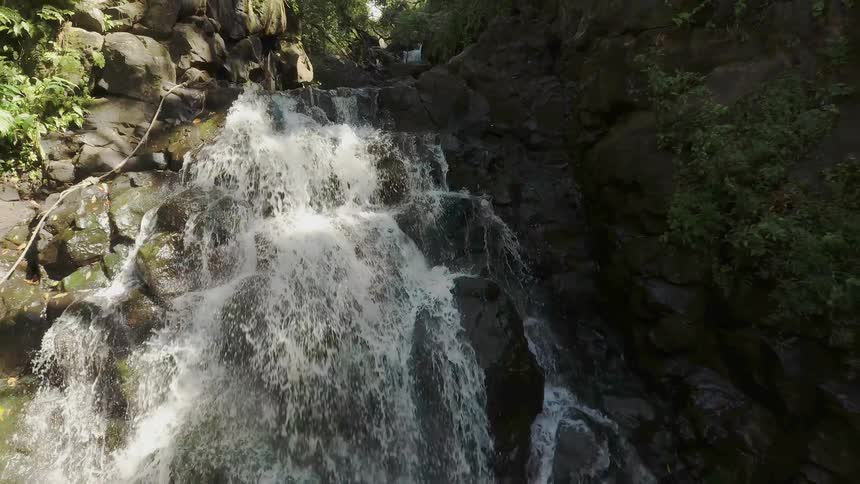 Water splashes down in a waterfall over rocks