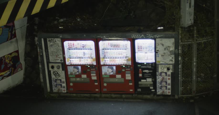 Vending machines are illuminated on the street at night