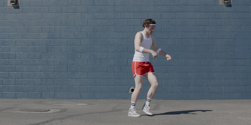 A man wearing red shorts dances on the court