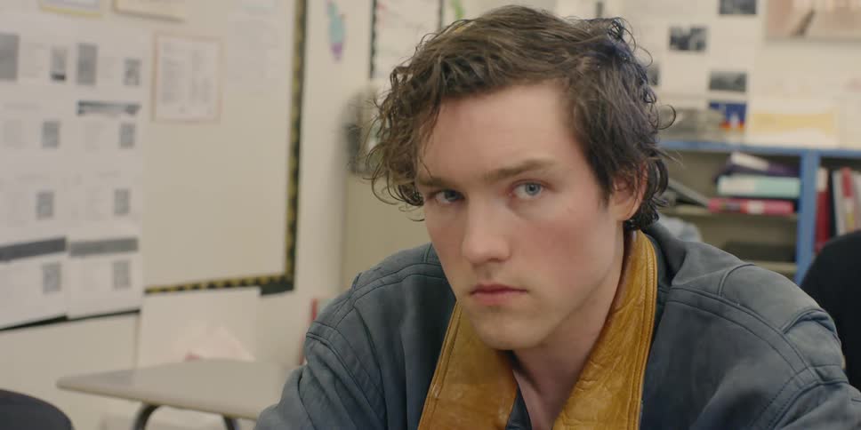 A high school student sits at a desk