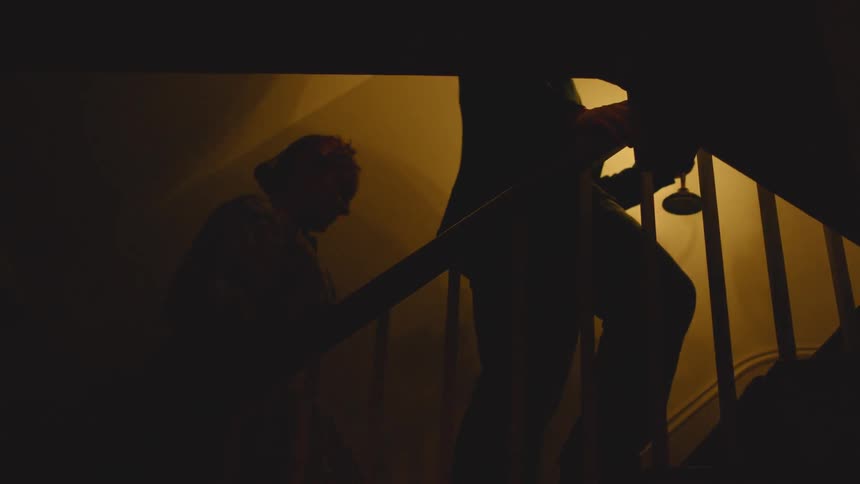 A man walks up the steps with candles