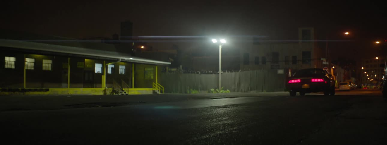 A car driving through a city area at night