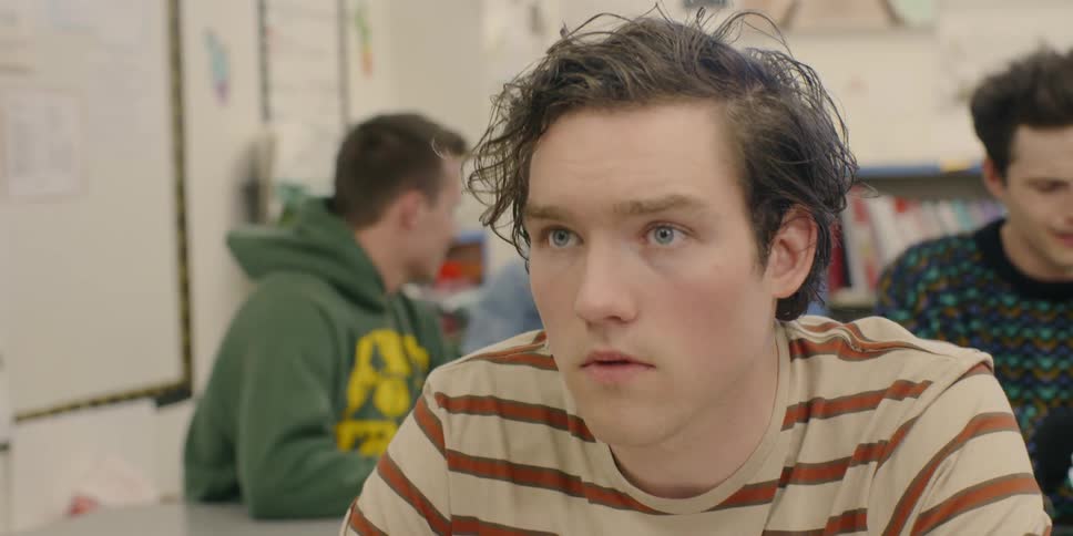 A boy sitting in class looks up