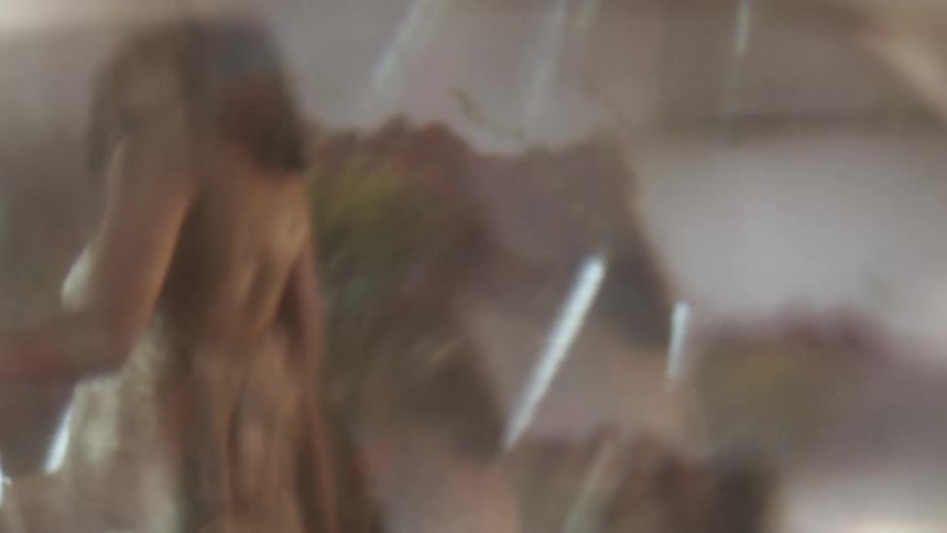 The lens blurs as it records a woman walking