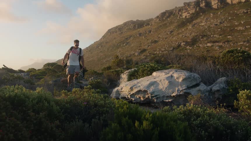 Backpacker walks across stones