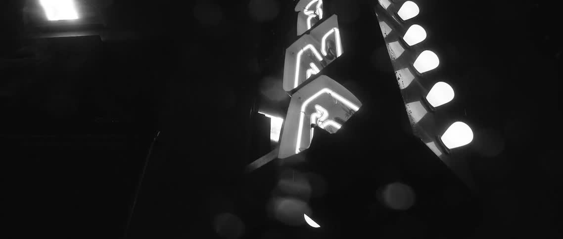 An illuminated sign glows at night