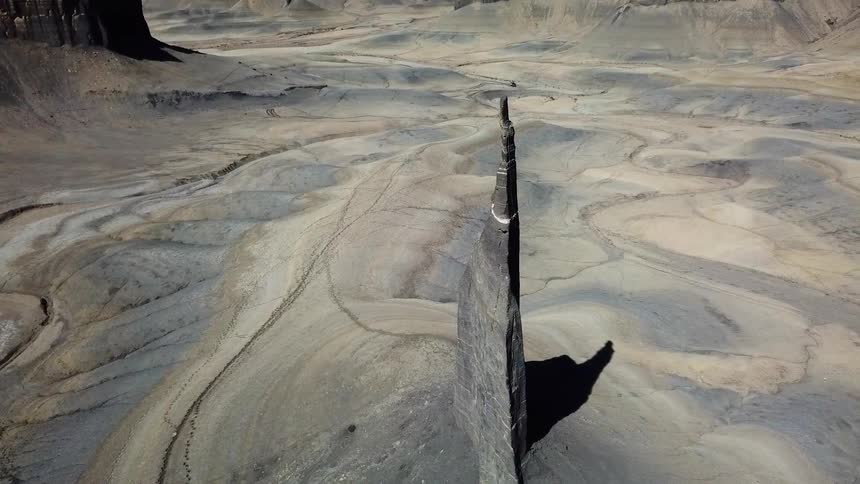 The tall sharp rock sits in the middle of the range