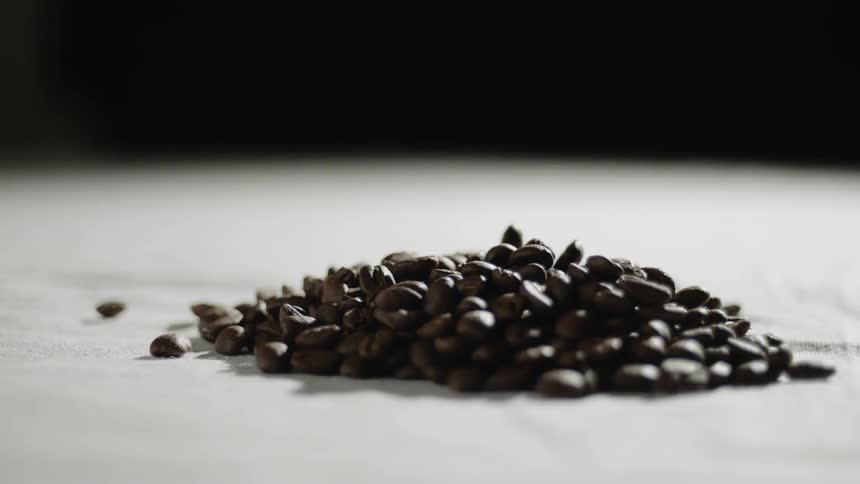 Coffee beans fall into a pile