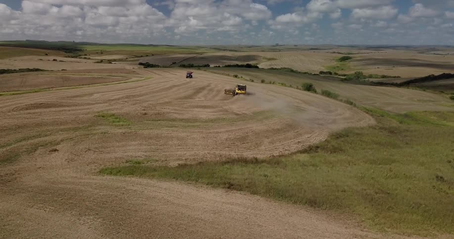 Multiple farm vehicles are working the fields