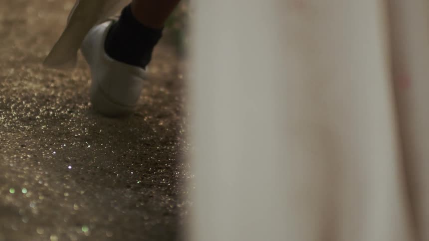 The person walks over the wet soil