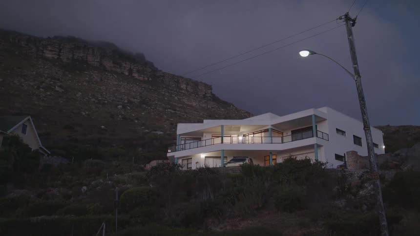 House sits on a hillside at night