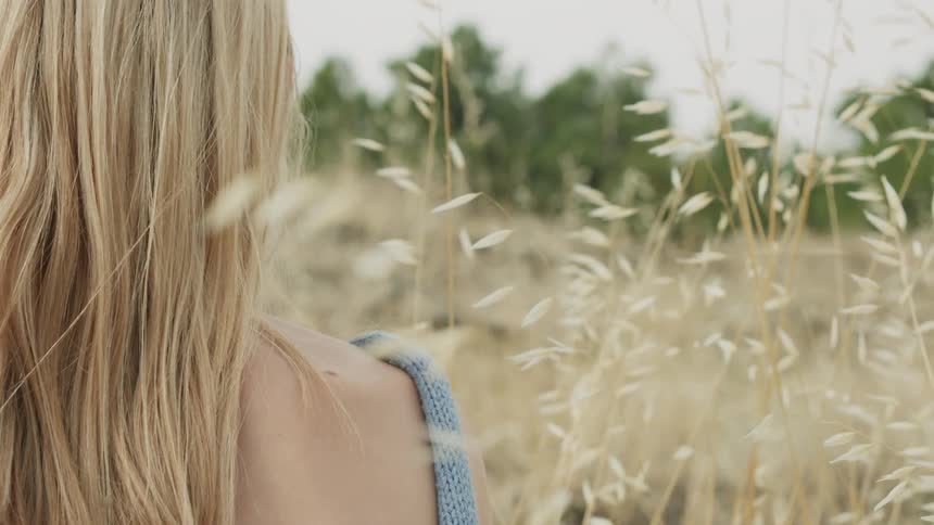 Woman sits in a rural field