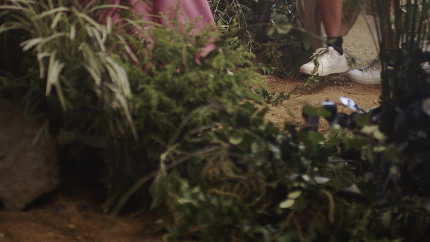 Person walks through grassy terrain