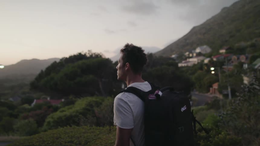 A man hikes with a large backpack